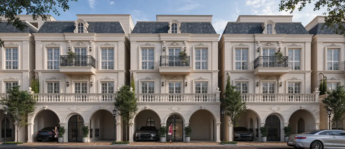 The cream rendered row houses at Godrej Florenne, with their arched car porches, iron balconies, and slate mansard roofs, seen from the internal street