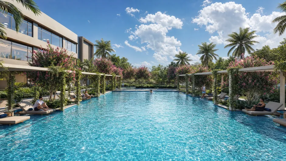 The club pool at Godrej Lakeside Orchard in daylight, with decking and planting along its edge