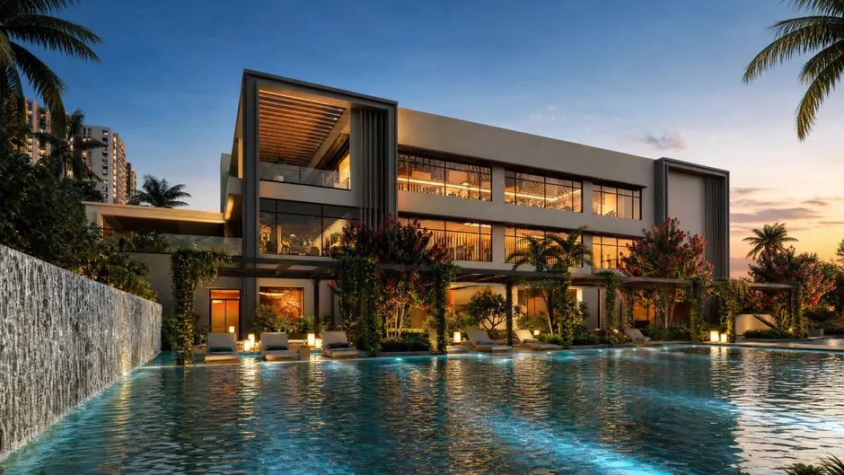 The club pool at Godrej Lakeside Orchard at dusk, lit from the water