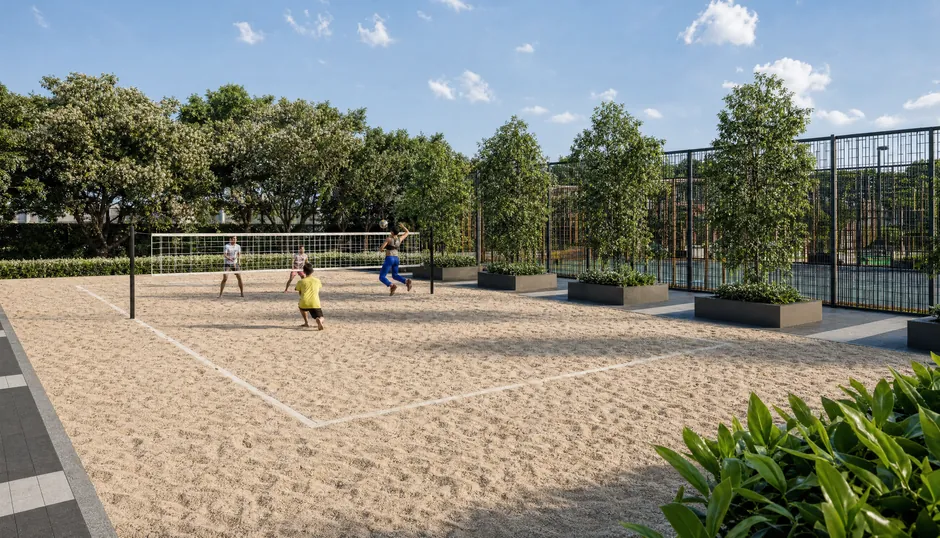 The beach volleyball court at Godrej Parkshire, with sand and a net between planted borders
